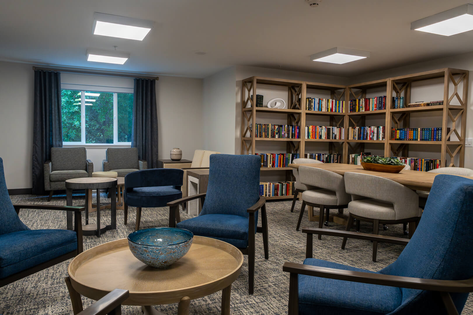 Library With Extensive Book Collection at Senior Living Apartments