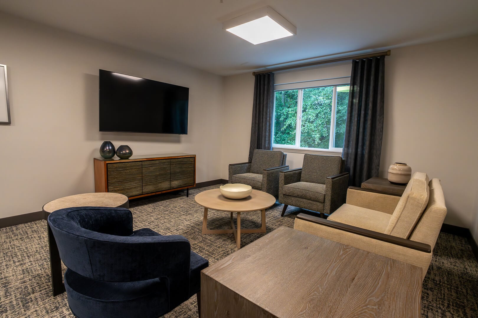 Cozy TV Lounge With Entertainment Center at Senior Living Facilities