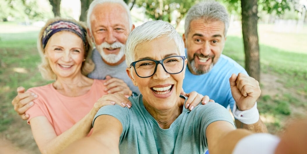 Group of Seniors Taking Selfie Outdoors at Independent Living Facility