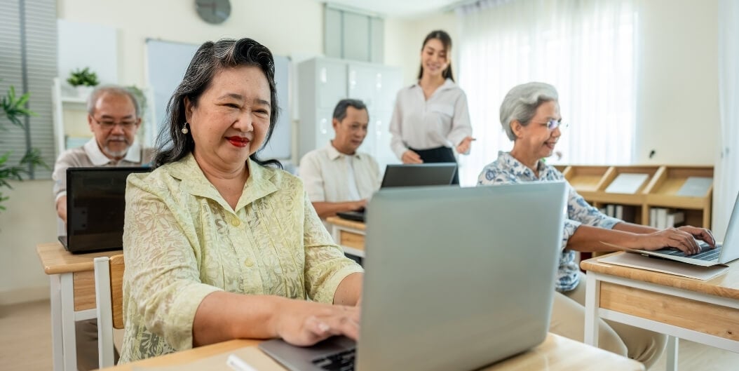 Elderly Residents Attending a Laptop Class with Nursing Staff at an Independent Living Facility