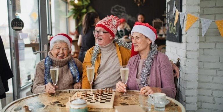 Elderly Friends Celebrating Christmas with Chess at Independent Living Facility