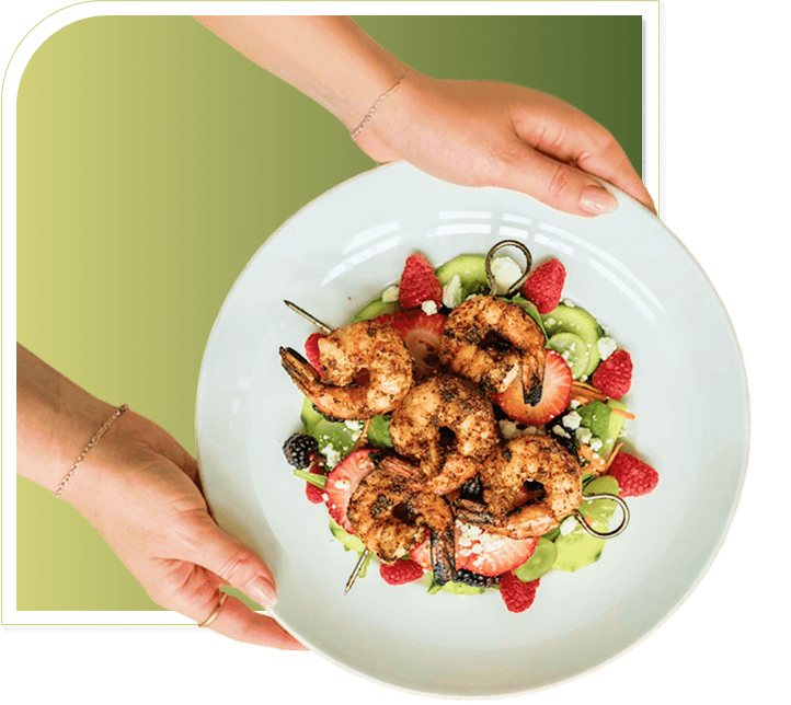Hands Serving a Fresh Shrimp Salad Plate at an Independent Living Facility Hands Serving a Fresh Shrimp Salad Plate at an Independent Living Facility