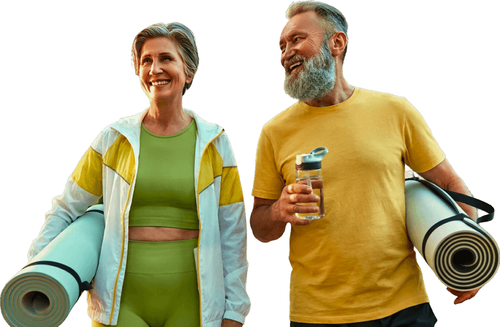 Smiling Elderly Couple Carrying Yoga Mats Outdoors at an Independent Living Community