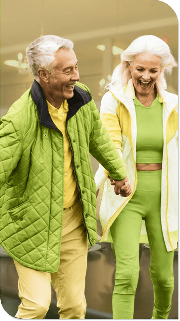 Happy Elderly Couple Holding Hands and Walking at Our Independent Living Community Happy Elderly Couple Holding Hands and Walking at Our Independent Living Community